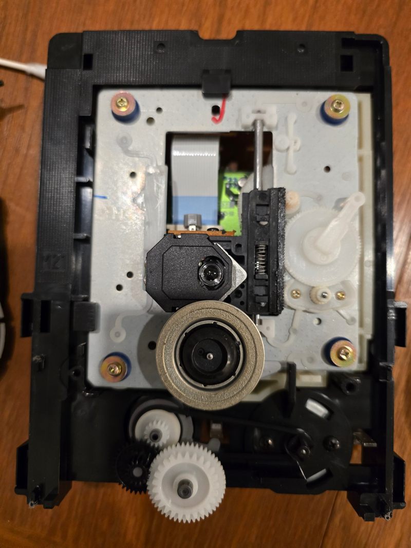 Exposed Sony KSS-213B laser pickup, spindle motor, guide rail and loading gears during Musical Fidelity A3.2 service